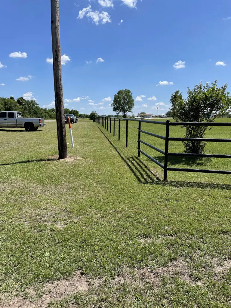 Rural property with metal fence and driveway access